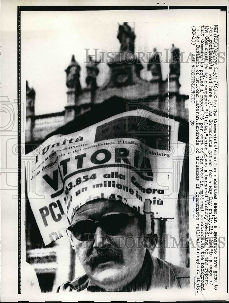 1963 Man wearing newspaper on a set with the headline victory - Historic Images