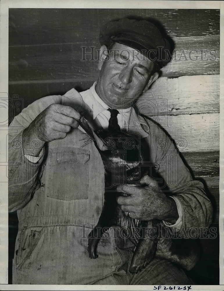 1934 Fred Chattern taking care of orphaned seal  - Historic Images