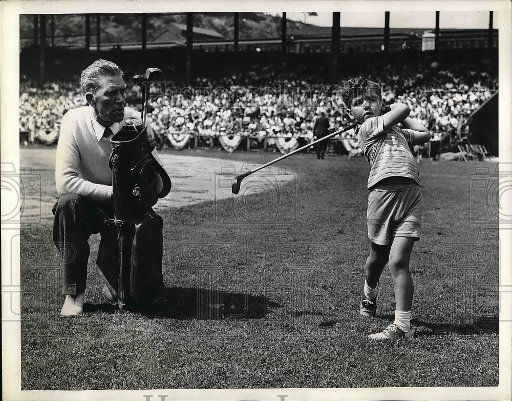 1941 Bobby Dawson Jr playing golf with his dad  - Historic Images