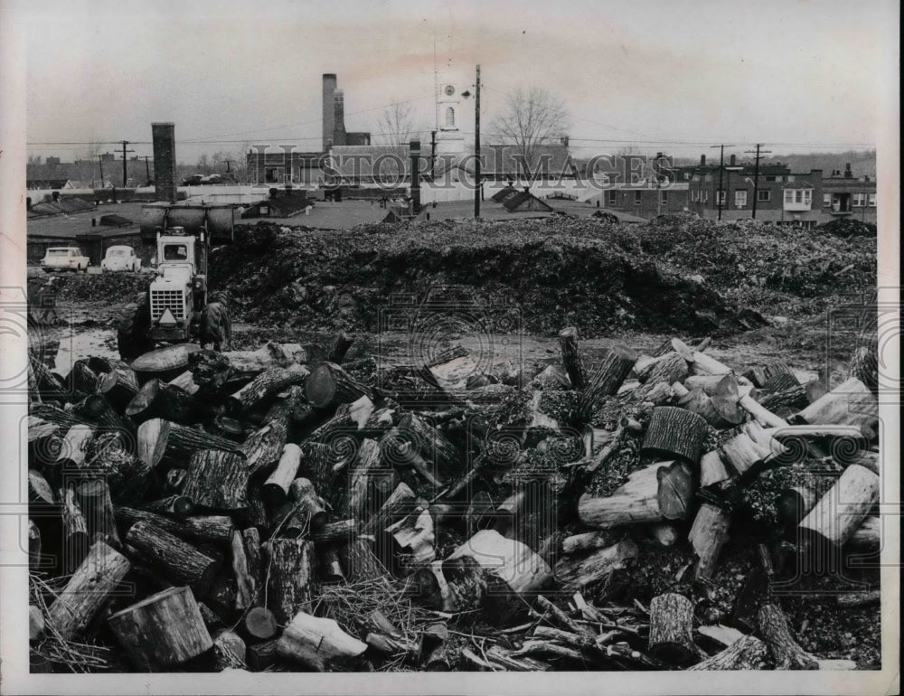 Press Photo Pile of wood and tractor - nea57858 - Historic Images