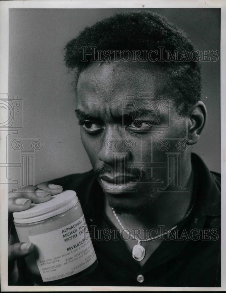 1970 Fred W. Hobbs, with jar of ointment sold to his mother - Historic Images
