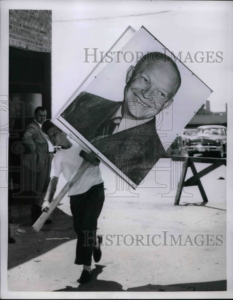 1952 Harry Rogers, holding the sign of President Eisenhower. - Historic Images