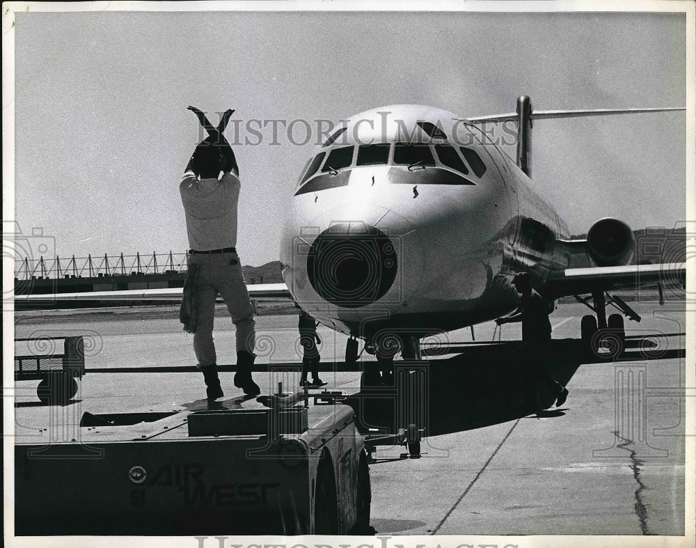 1970 Airport Worker Uses Modified Stop Signal  - Historic Images
