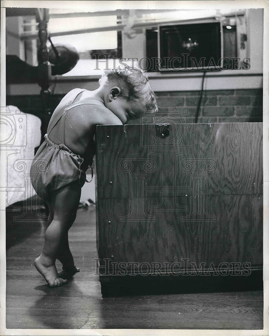 1957 Press Photo Keith Bowser searching for his favorite toy in St Louis home - Historic Images