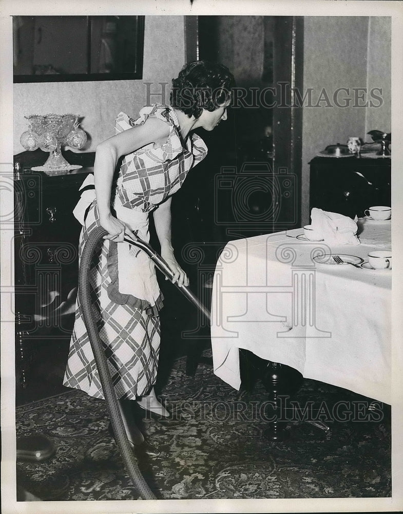 1937 Mrs. William Hayes vacuuming her house  - Historic Images