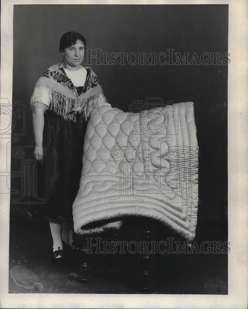 1929 Mrs. Louisa Pertick with a bed cover made out of sheeps wool. - Historic Images