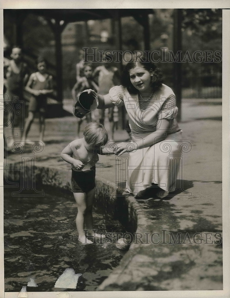 1932 Child playing in the pond in hot weather  - Historic Images