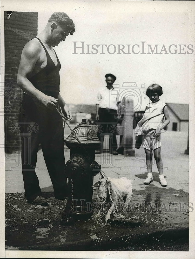 1933 Dog playing in water from fire hydrant  - Historic Images