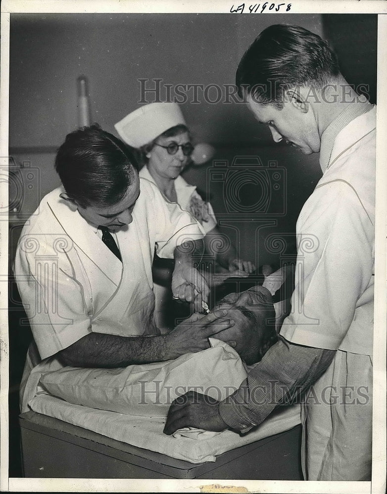 1937 Dr.John Kirkpatrick removing knife from the patients skull - Historic Images