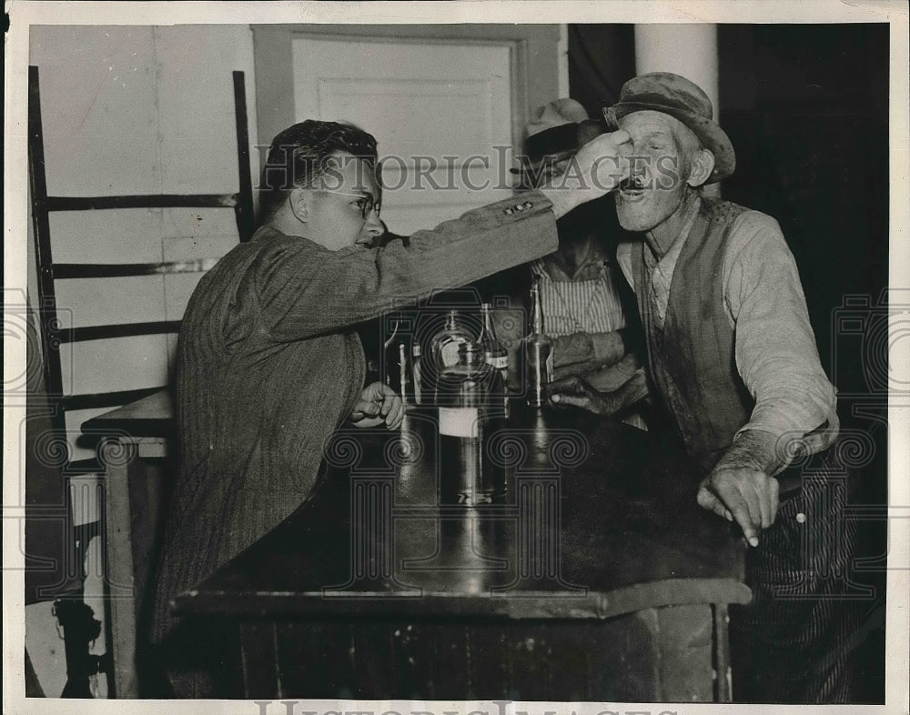 1938 Eugene White Administers Medicine to Sandy Lissenbee - Historic Images