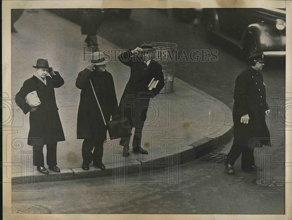 1938 Press Photo Men trying to keep their hats on, Policeman with earmuffs-Historic Images