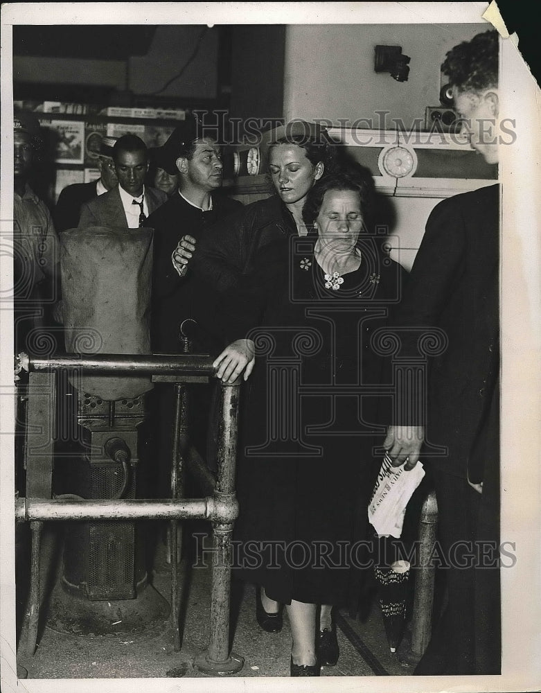1937 Press Photo Women Come through Turnstile Headed to Ambulance - nea64792 - Historic Images