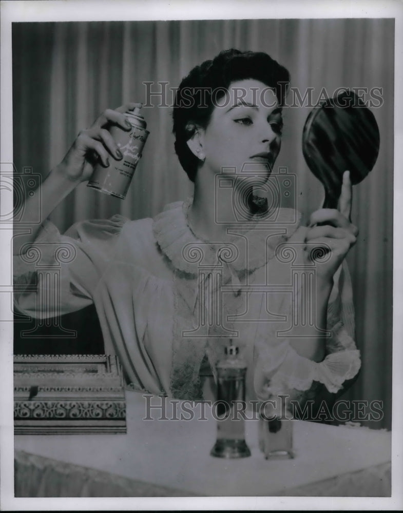 1954 A model with her hair spray in front of amirror  - Historic Images