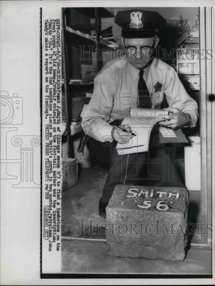 1956 Frank J. Smith inspects tombstone placed on his home - Historic Images