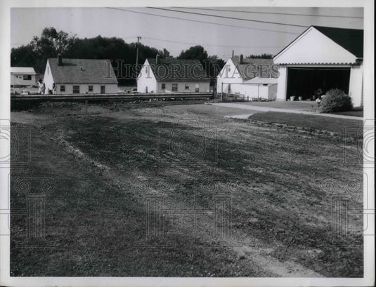 1962 General view of a town with cinders dumped to stop water flow - Historic Images