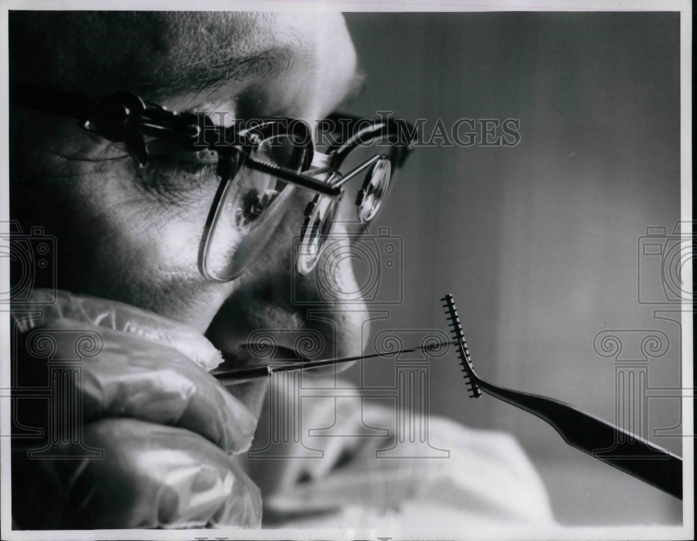 1961 Press Photo Westinghouse Scientist Trims an Experimental Ionic Switch Gap - Historic Images