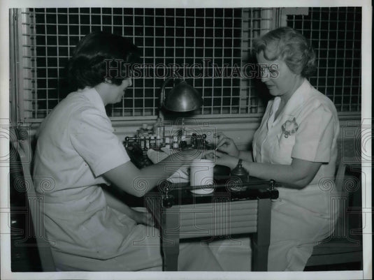 1958 Mentally handicapped women receive beauty treatment  - Historic Images