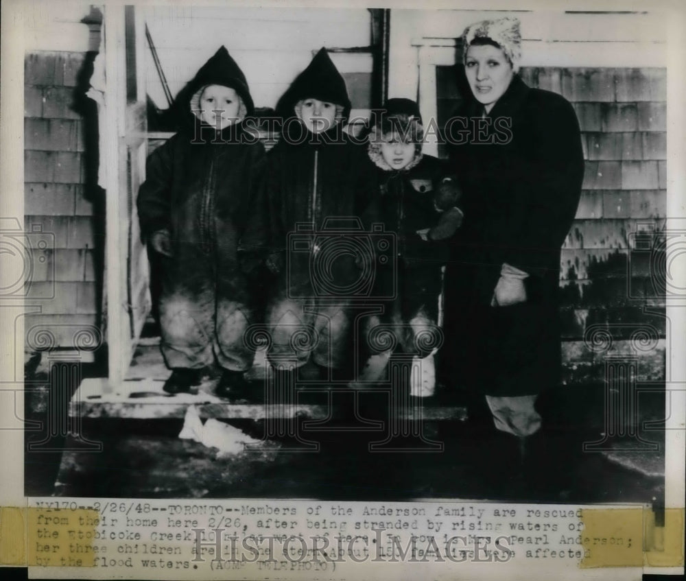 1948 Press Photo Members of the Anderson family rescued from their home after-Historic Images