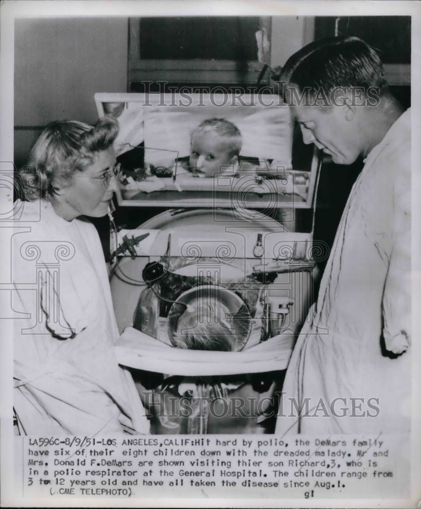 1951 Mr. and Mrs. Donald DeMars, son Richard, 3, who has polio - Historic Images
