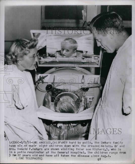 1951 Mr. and Mrs. Donald DeMars, son Richard, 3, who has polio - Historic Images