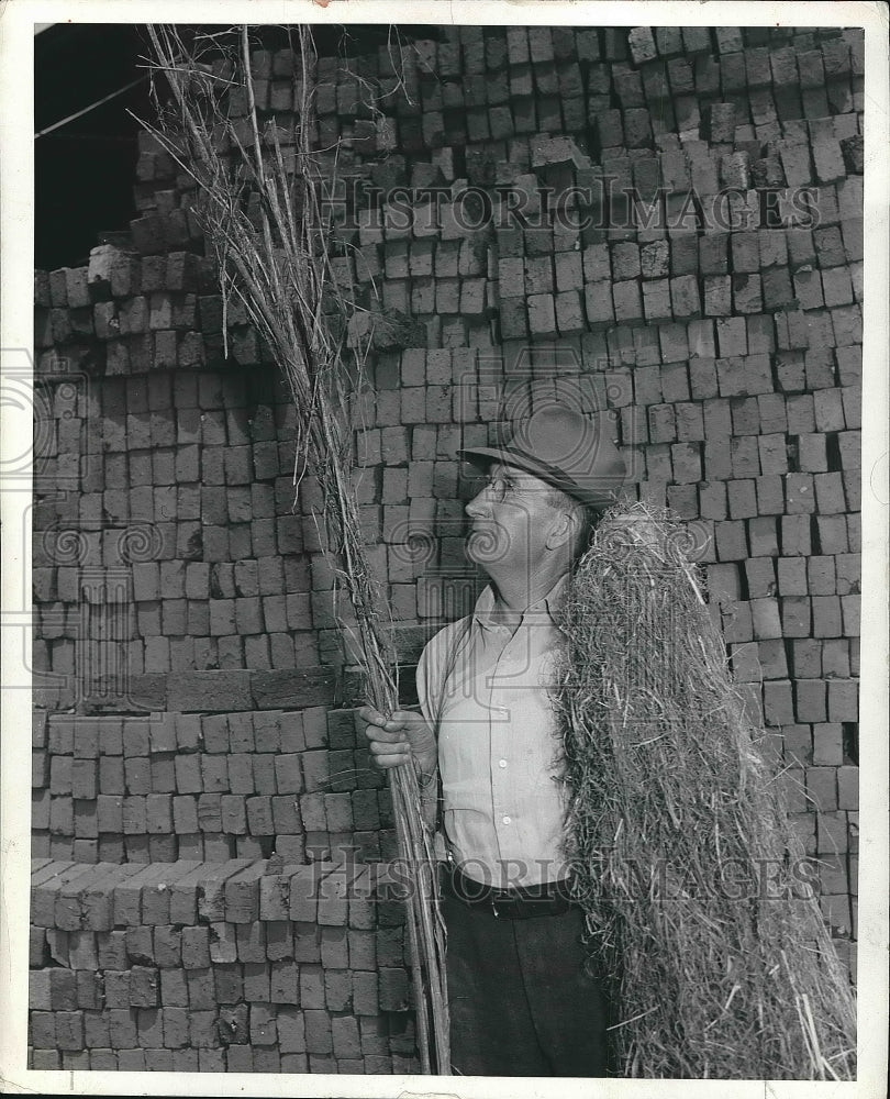 1942 Press Photo Man with Sticks - Historic Images