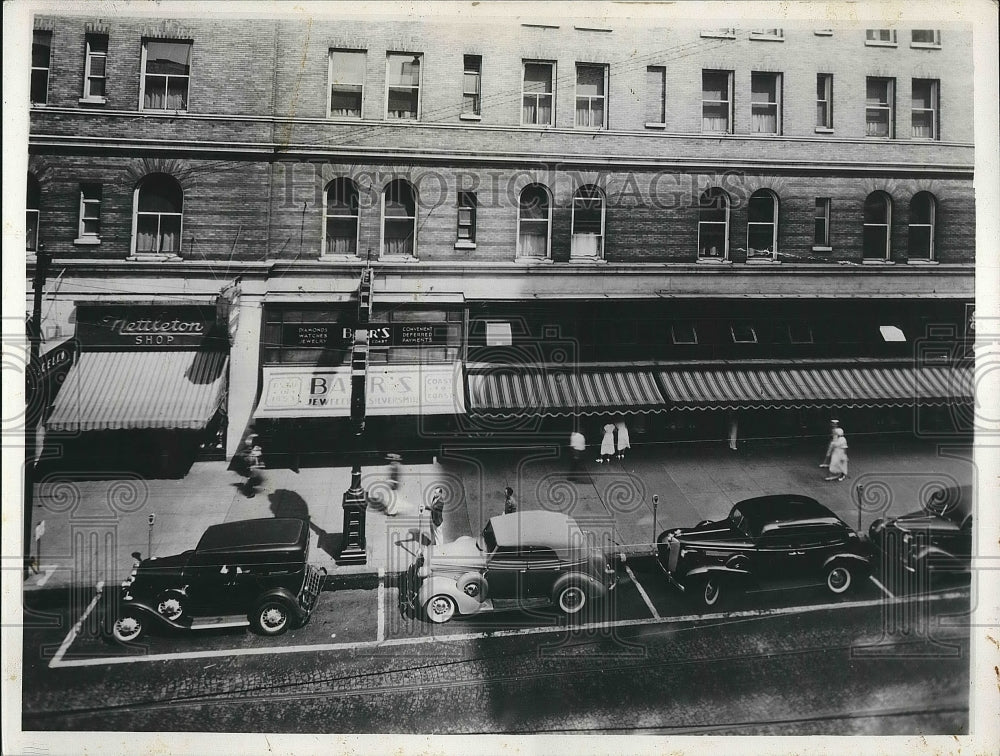 1938 Cars parked outside of store fronts.  - Historic Images