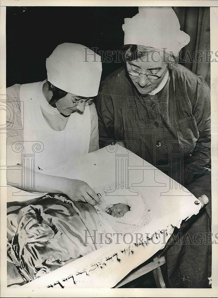 1938 Angela Morton being fed in a cotton - Historic Images