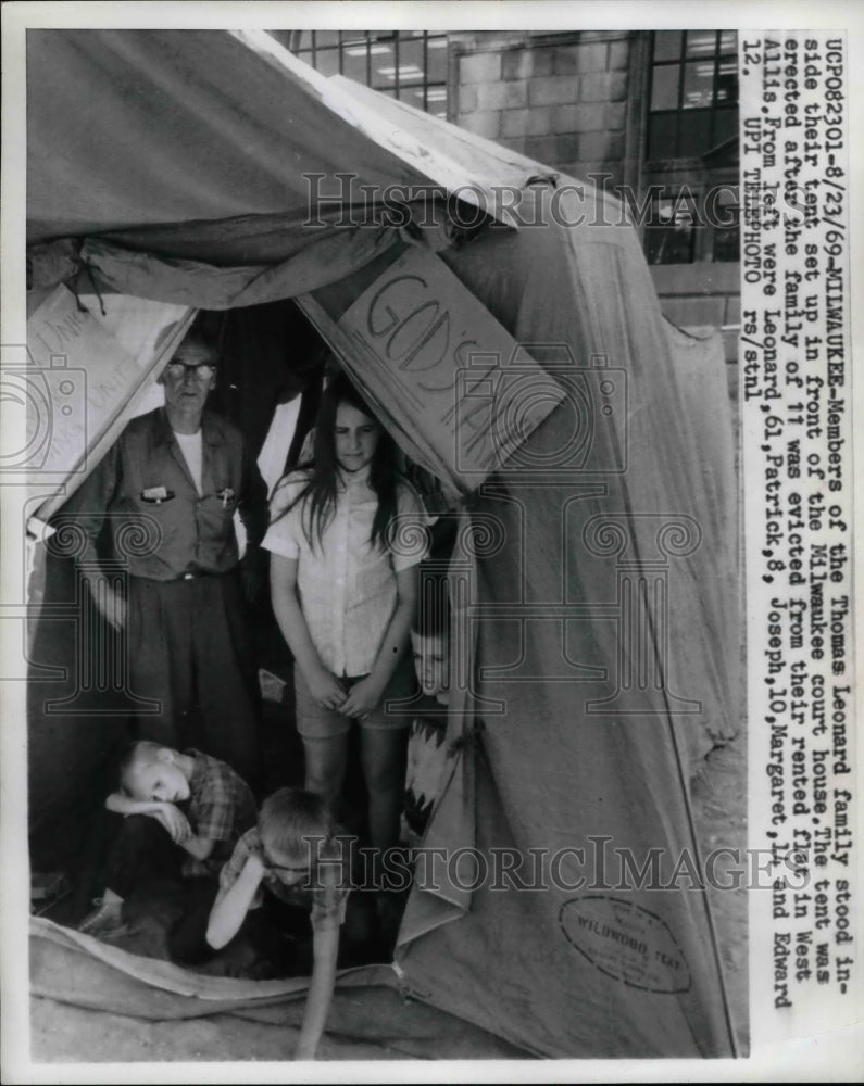 1969 Members of Thomas Leonard family in tent, front of court house - Historic Images