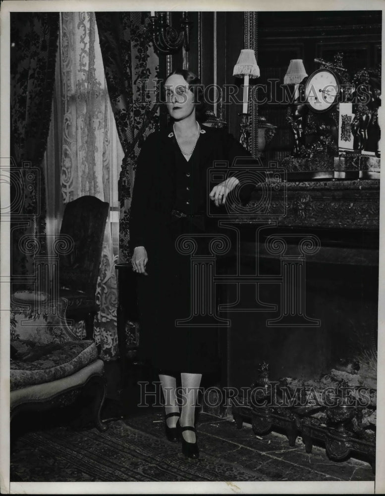 1932 Mrs O.L. Mills at the fireplace in her home  - Historic Images