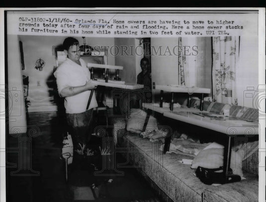 1960 Press Photo Florida Home owner stacks his furniture in two feet of water. - Historic Images