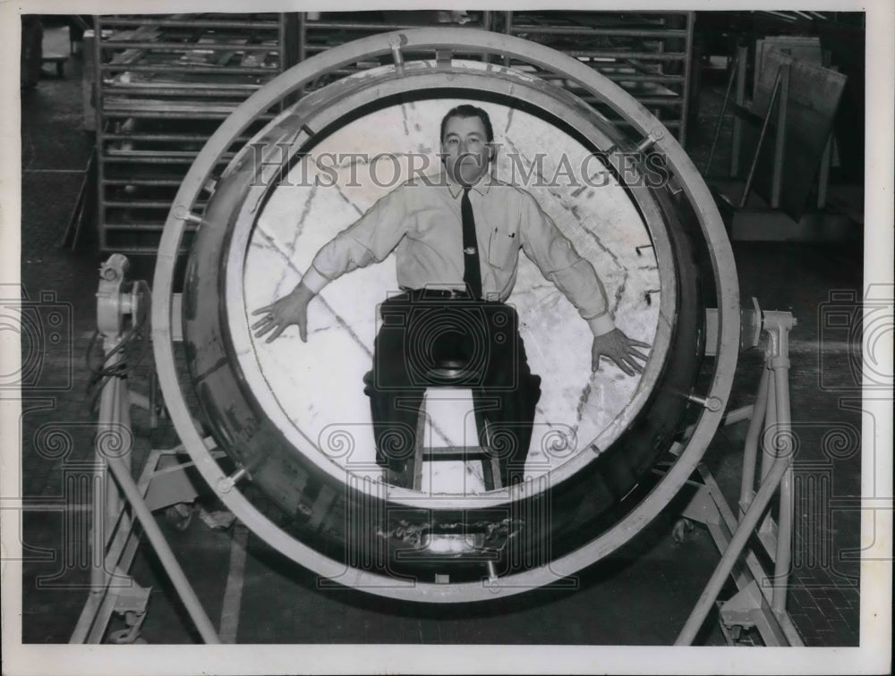 1959 A man inside a searchlight frame in a demonstration of it - Historic Images