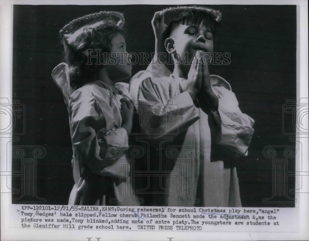 1955 Philomine adjusts Tony's slipping halo in school Christmas play - Historic Images