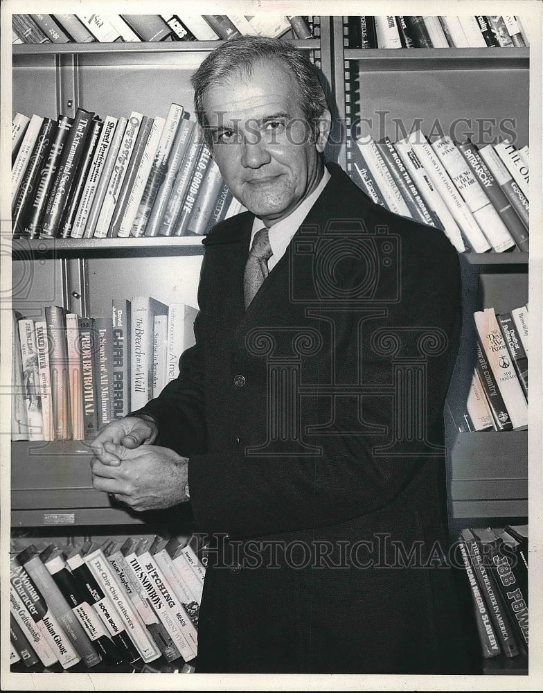 OG Mendino standing in front of bookshelf  - Historic Images