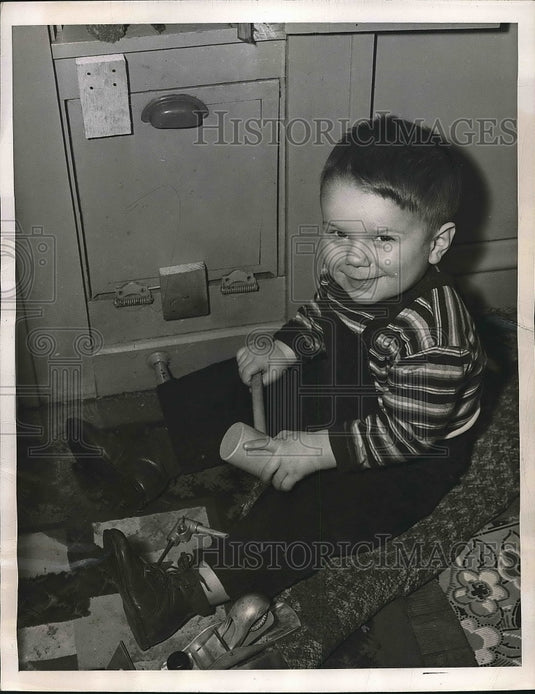 1946 Bobby Cunningham after being rescued by police and firefighters - Historic Images