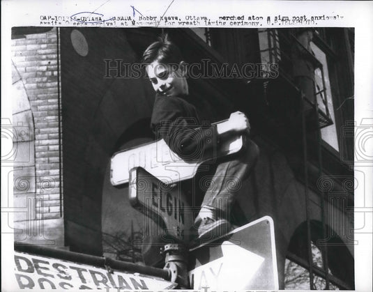 1957 Bobby Reeve sits on a sign post in Ottawa, Canada  - Historic Images