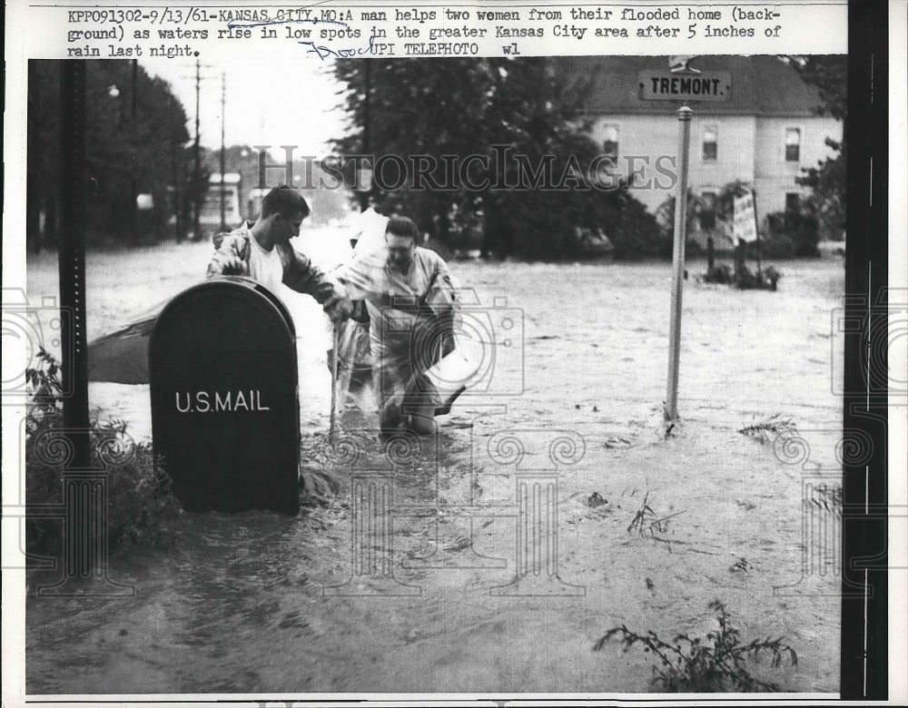 1961 Man helped a women from a flooded home in Kansas City,Mo. - Historic Images