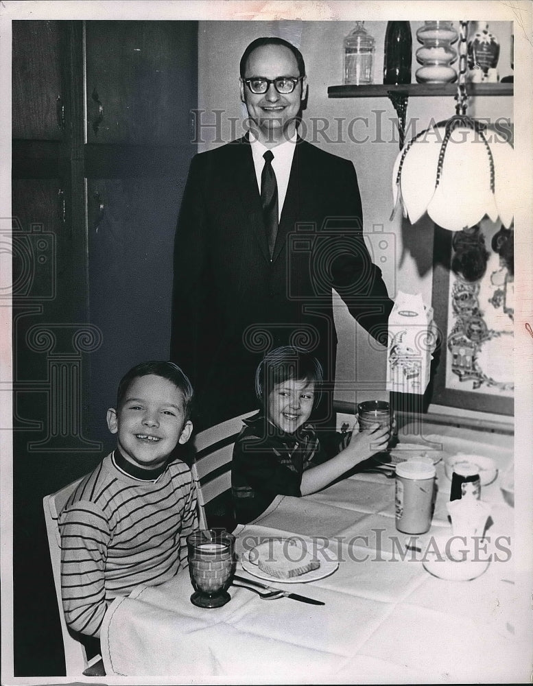 Press Photo Man gives his children glasses of milk - nea72535 - Historic Images