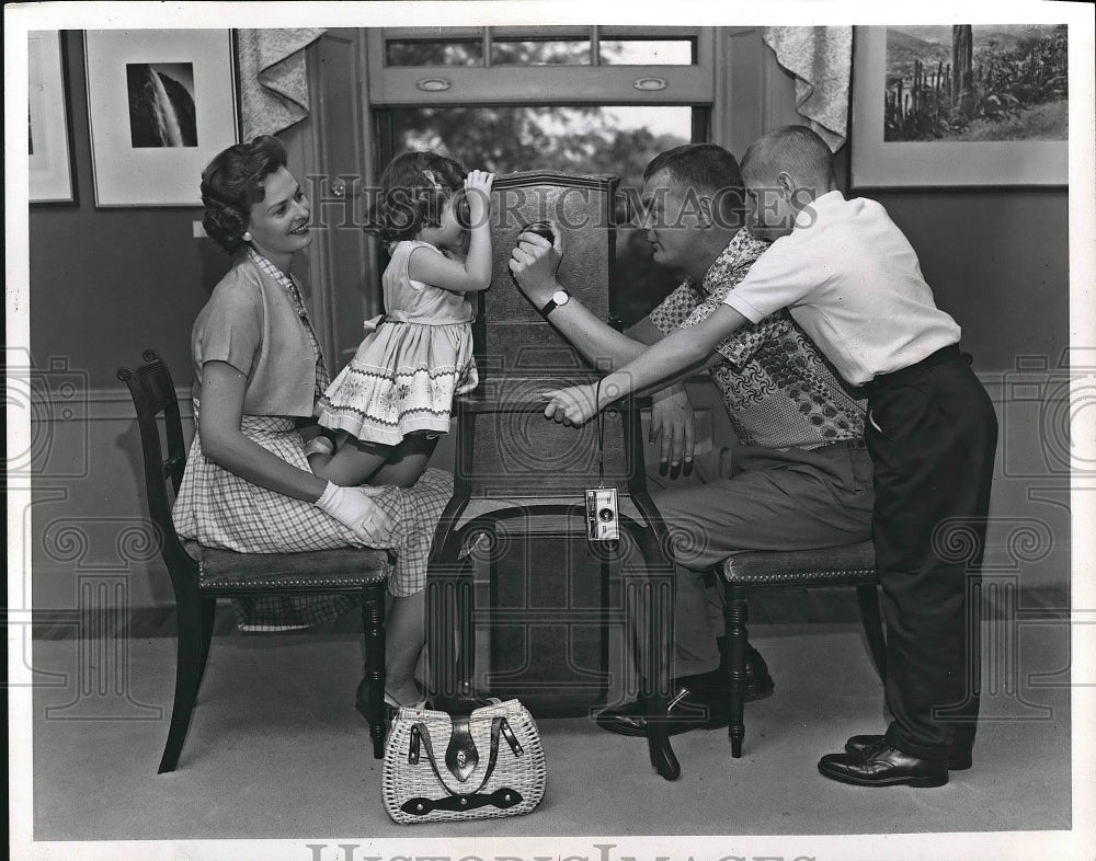 1965 Family looking into a photo box  - Historic Images