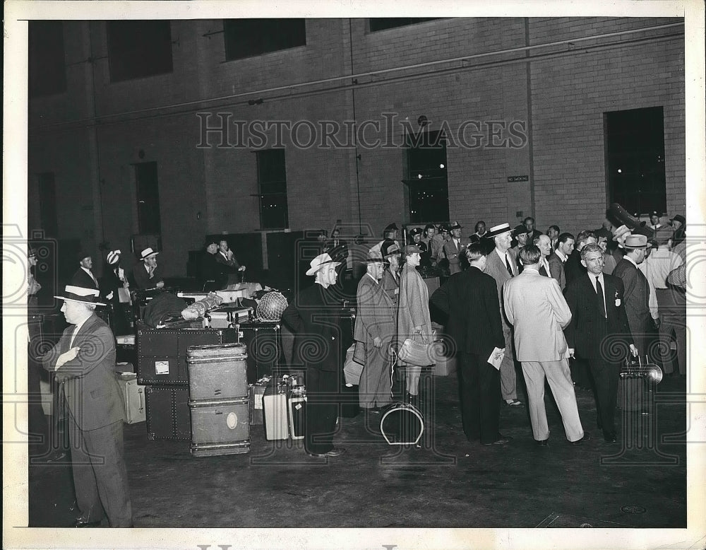 1941 Group of people inside of a hanger with baggage  - Historic Images
