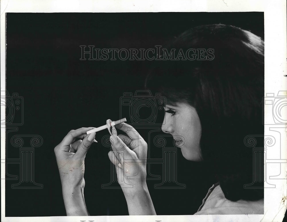 1969 San Francisco. Ca. girl demonstrates use of smoke ring for cigs - Historic Images