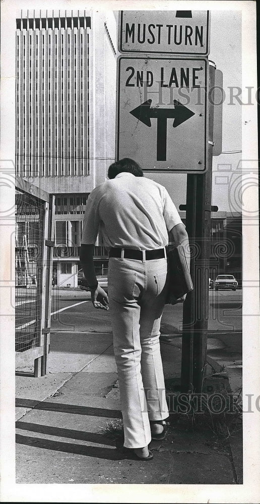 1971 Youth trying to evade low hanging traffic sign at E 22 & Enulid - Historic Images