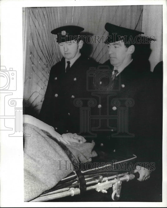 1972 Rescue workers carry girl from Film Center Theater after bomb - Historic Images