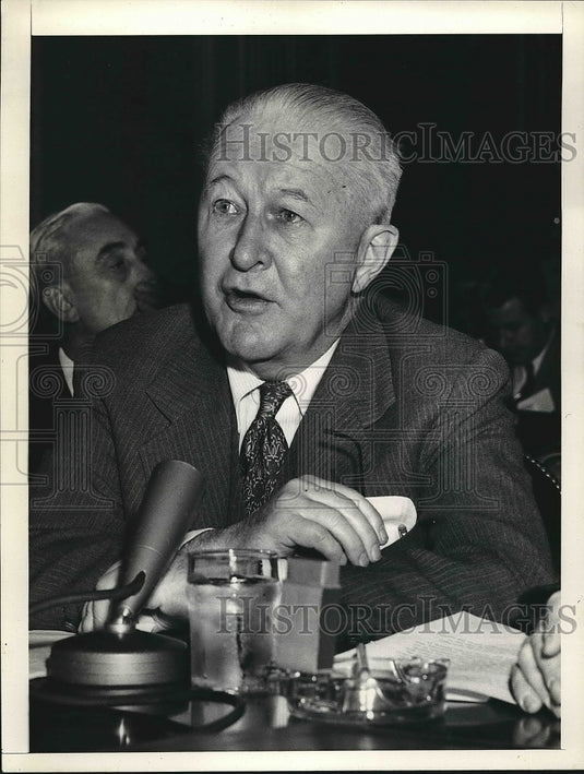 Press Photo Man Sitting At Table With Microphone Speaking - nea73962-Historic Images