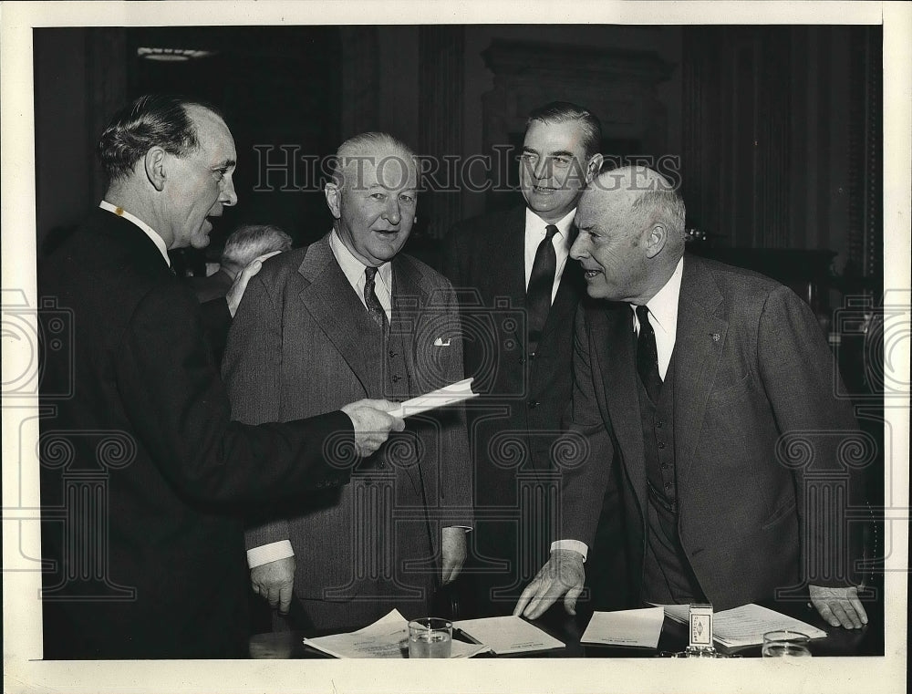 Men in coats talking  - Historic Images