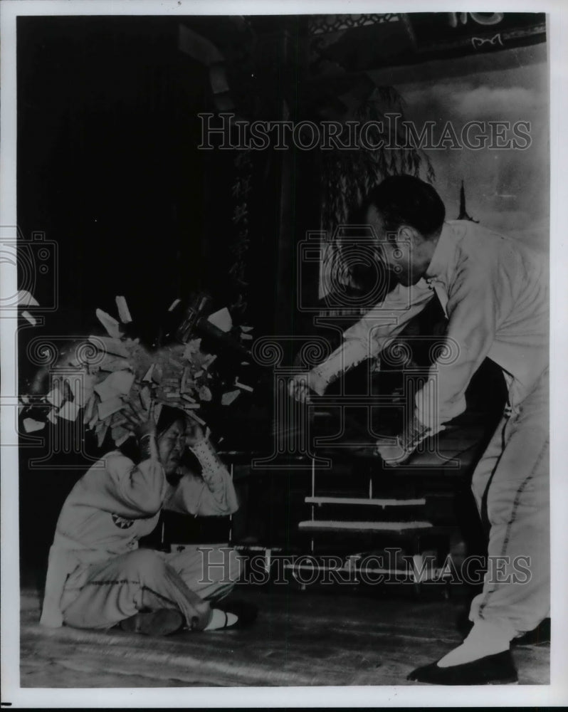 Press Photo Man smashed fruit with hammer over ladies head - nea74424 - Historic Images
