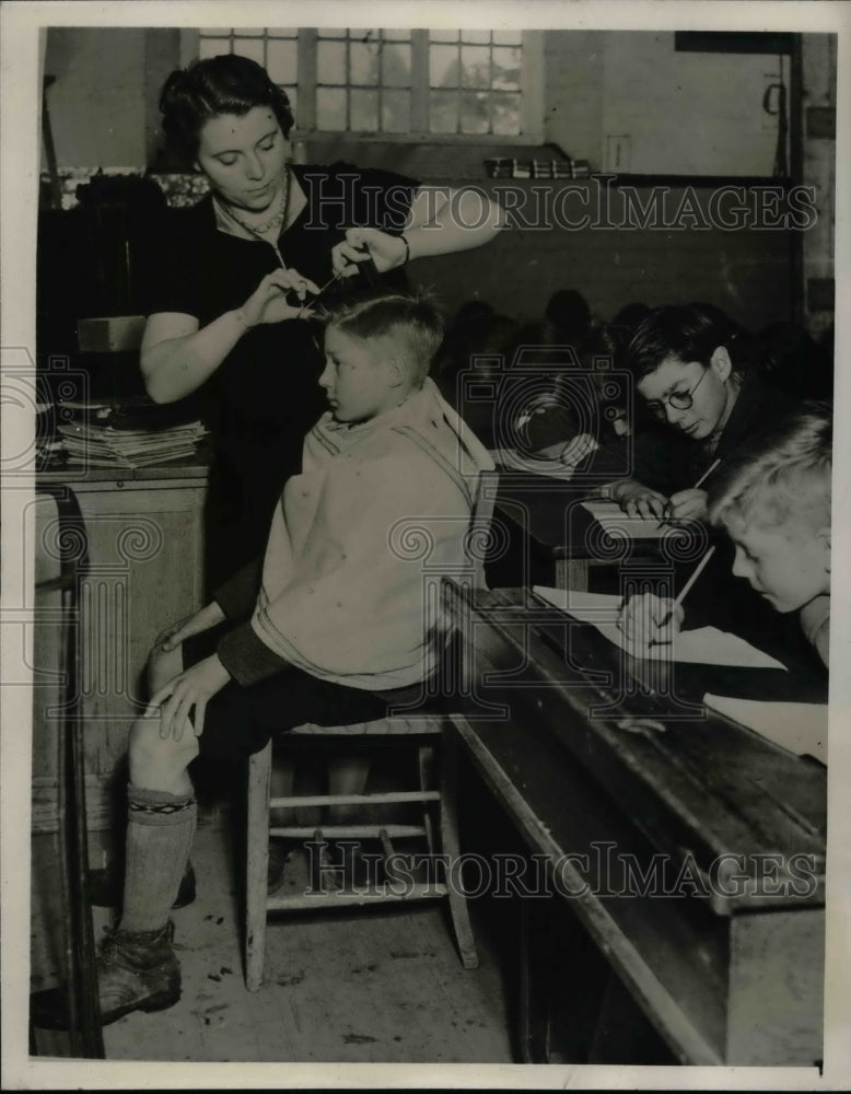 1940 Teacher E. Jones Cutting Child's Hair in Classroom  - Historic Images