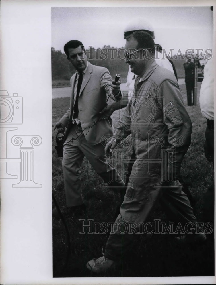 1967 Pilot Jim Beele Walking with Press Giving Interview  - Historic Images