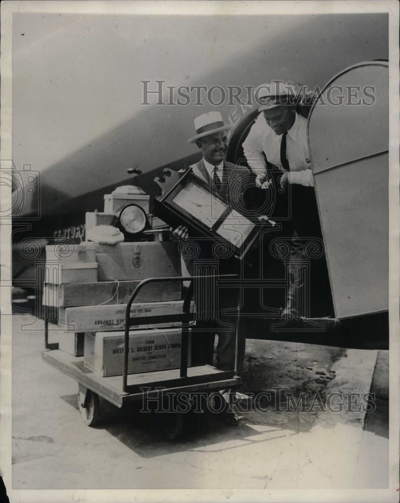 1931 Press Photo Bleuher Company Pilot Loading Timepieces onto Airplane - Historic Images