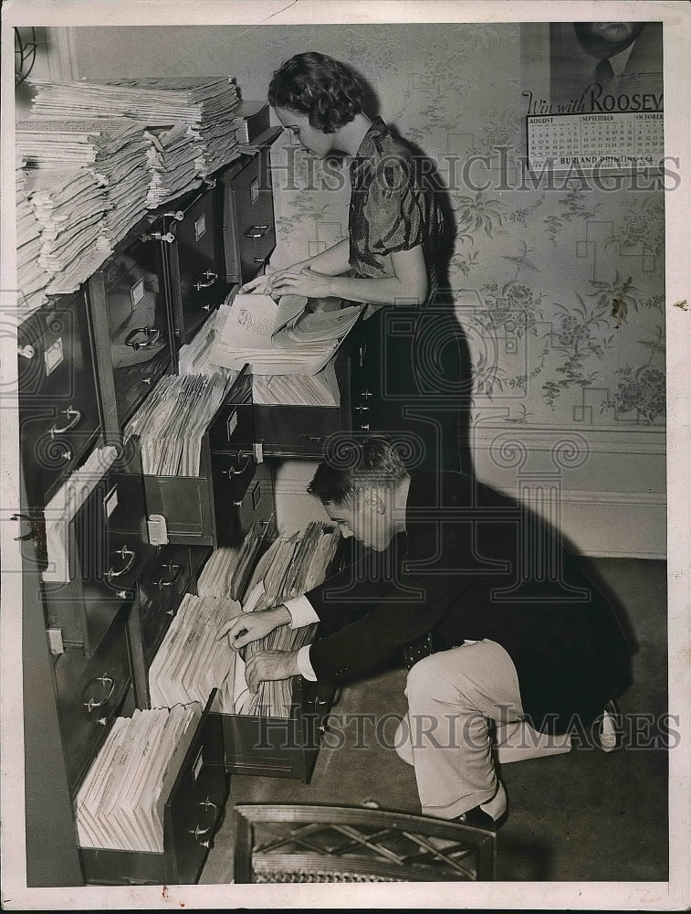 1937 Man &amp; woman at work in a research file room  - Historic Images