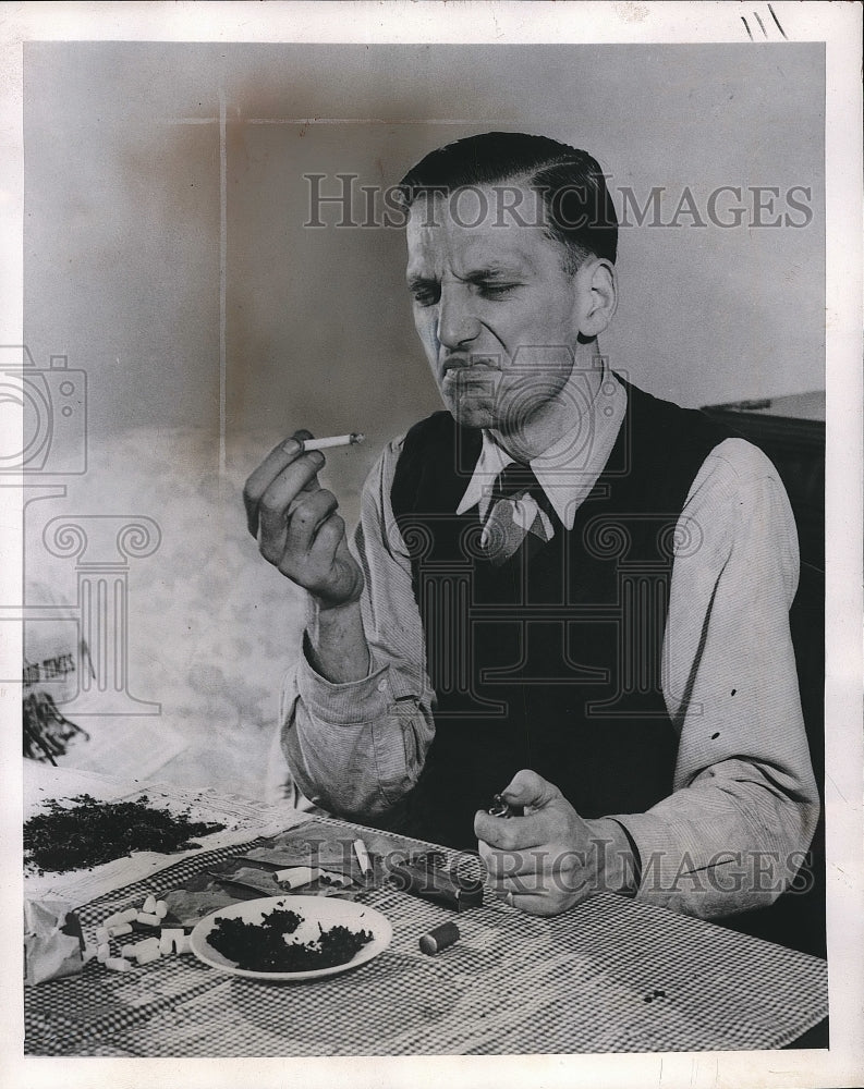 1947 Mr Spencer&#39;s reaction to his home made cigarettes  - Historic Images